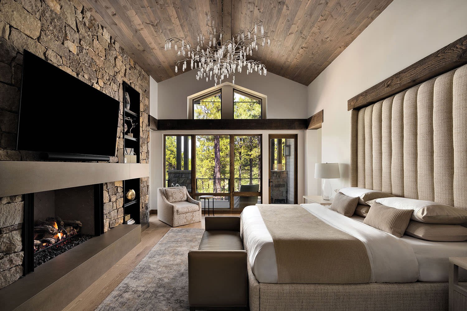 Rustic Master Bedroom Design with Botanical Prints and Stone Wall