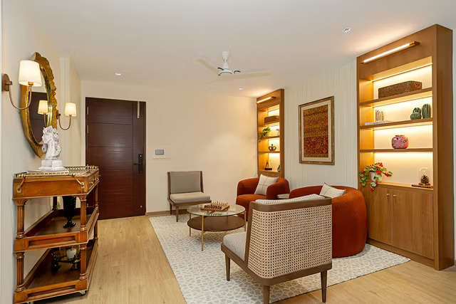 Classic Living Room Design Featuring Maroon Sofas, Wooden Tables, and TV Console